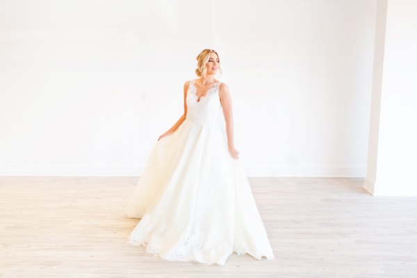 Woman posing in a wedding dress. 