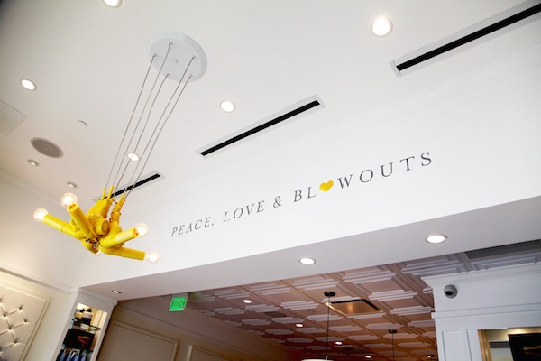 Inside the new Drybar with "Peace, love and blowouts" painted on the wall.