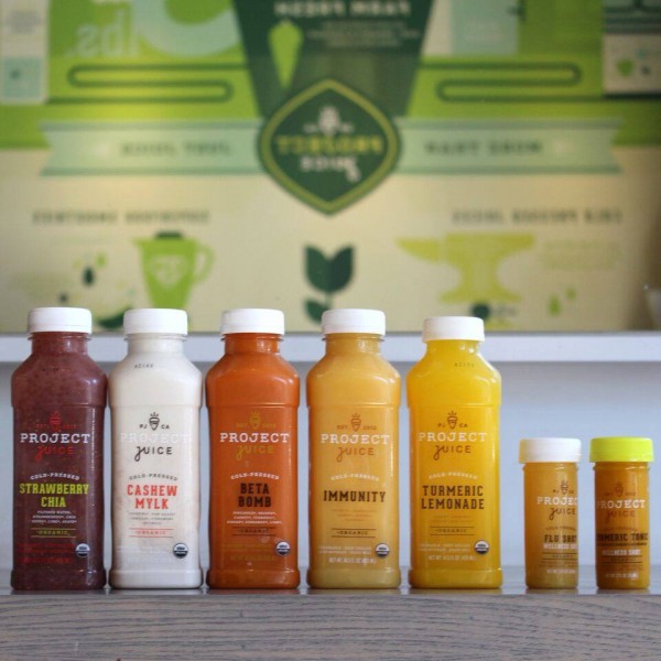 Line up of different juice options from Project Juice including strawberry chia, cashew milk, beta bomb, immunity, and tumeric lemonade