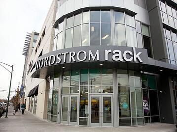 Nordstrom Rack storefront with many windows on a street corner