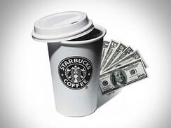 Black and white image of a starbucks cup with the lid half on and stack of cash bills fanned out behind the cup