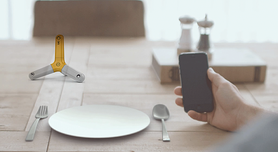 Diner holding iPhone at dinner table in restaurant