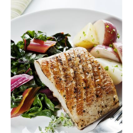 Seafood on the Grill image of grilled fish on salad plate with roasted potatoes