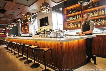 Fancy bar inside Nordstrom with sleek and modern detailing with bartender behind the bar