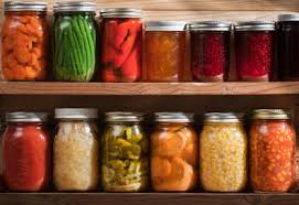 Two shelves of canned vegetables in mason jars