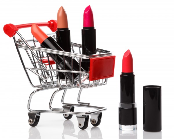 colorful pink and nude lipsticks in black casing inside of a mini shopping cart