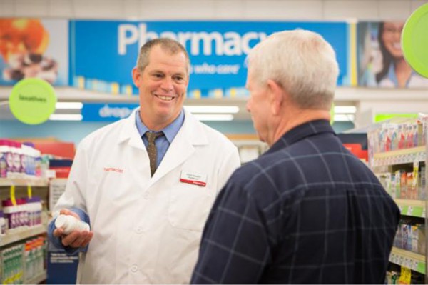 CVS pharmacist showing helping an elderly gentleman.  