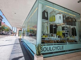 soulcycle store front with clothing rack featuring items for purchase