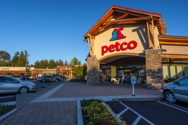 Petco storefront on the corner of a plaza late in the afternoon. 