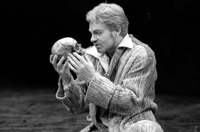 Actor in Shakespeare's "Hamlet" holding and speaking to a skull