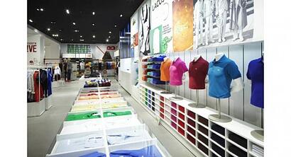 inside a clothing store with colorful men's polo shirts on display