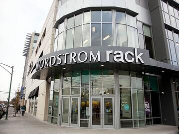 nordstrom rack storefront with many windows on a street corner