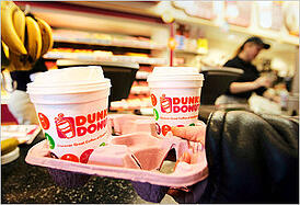 two holiday dunkin donuts coffee cups in a carryout container from within the dunkin location