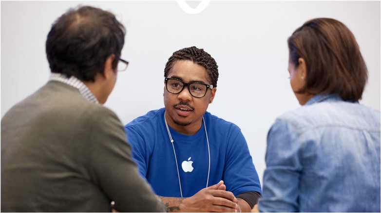 face to face interactions between an Apple store worker and a man and woman couple