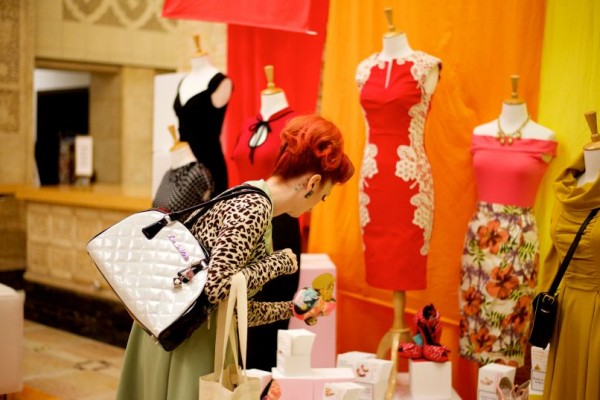 woman shopping in modcloth boutique store with dresses and trinkets on display