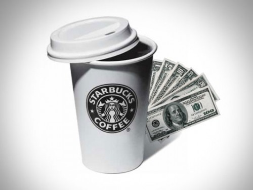 black and white image of a starbucks cup with the lid half on and stack of cash bills fanned out behind the cup