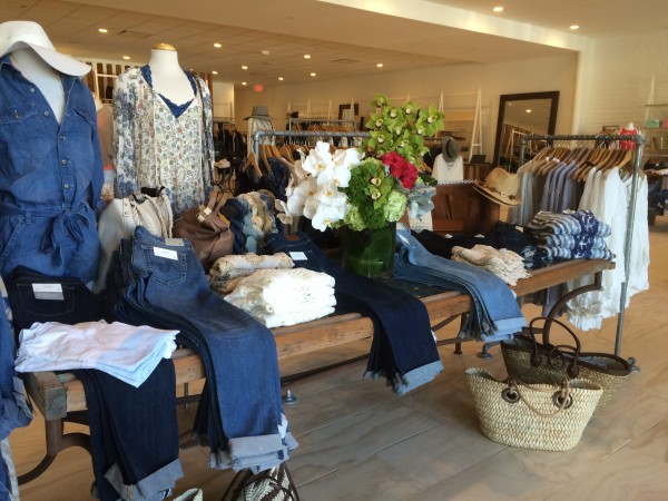 Inside of a M Fredric store with jeans and shirts on display in the front of the store