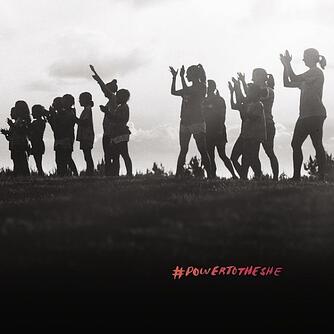 hashtag power to black and white image of women on a hill clapping, with the hashtag power to the she.                       