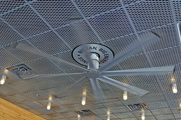 Large industrial fan with metal ceiling inside of a Burgerfi