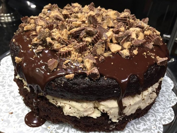 chocolate whoopie pie cake with chocolate sauce and peanut butter cups on top