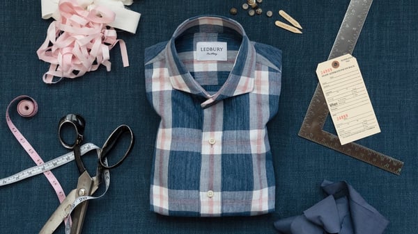 Ledbury flannel shirt on a table with scissors and measuring tape next to it.