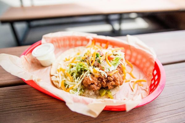 paper lined red basket with taco inside