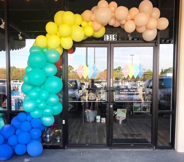 rainbow balloon arch over a doorway