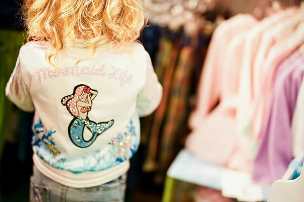 Young girl wearing a mermaid life rhinestone jacket