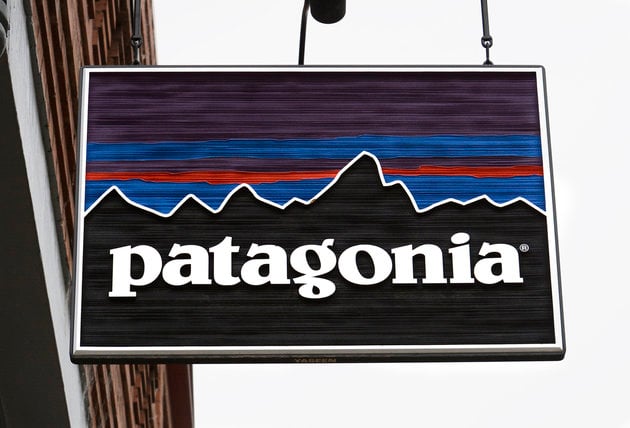 Hanging wooden sign of Patagonia mountain logo. 