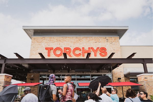 Torchy's storefront with people outside