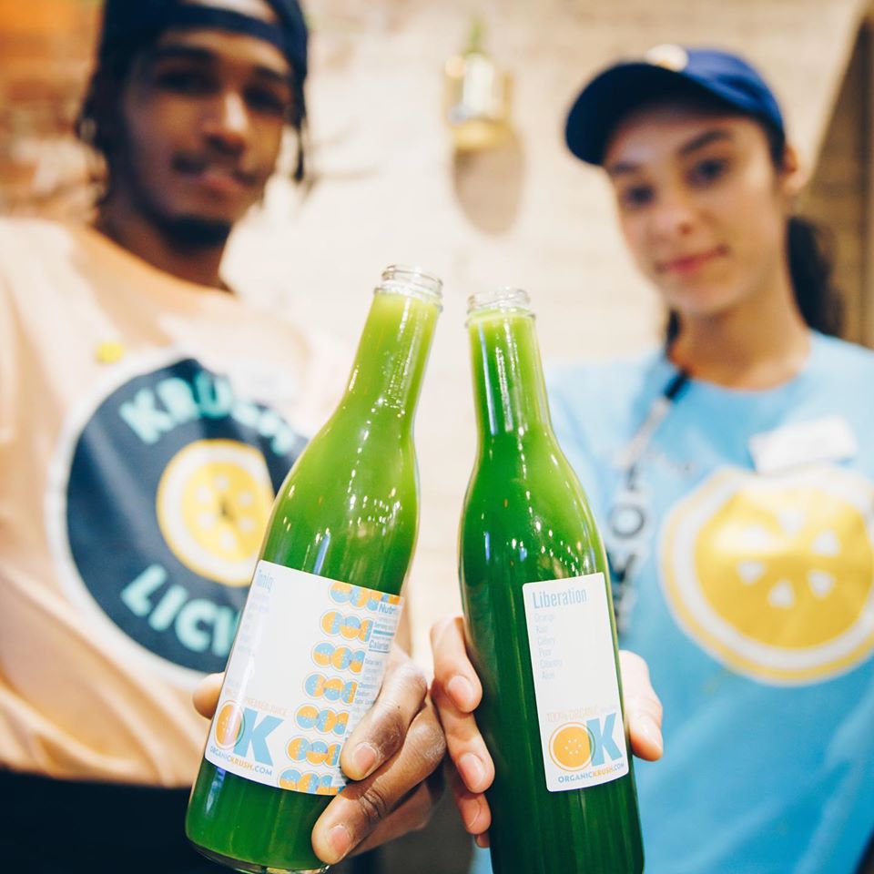 Organic Krush Staff Holding Juices