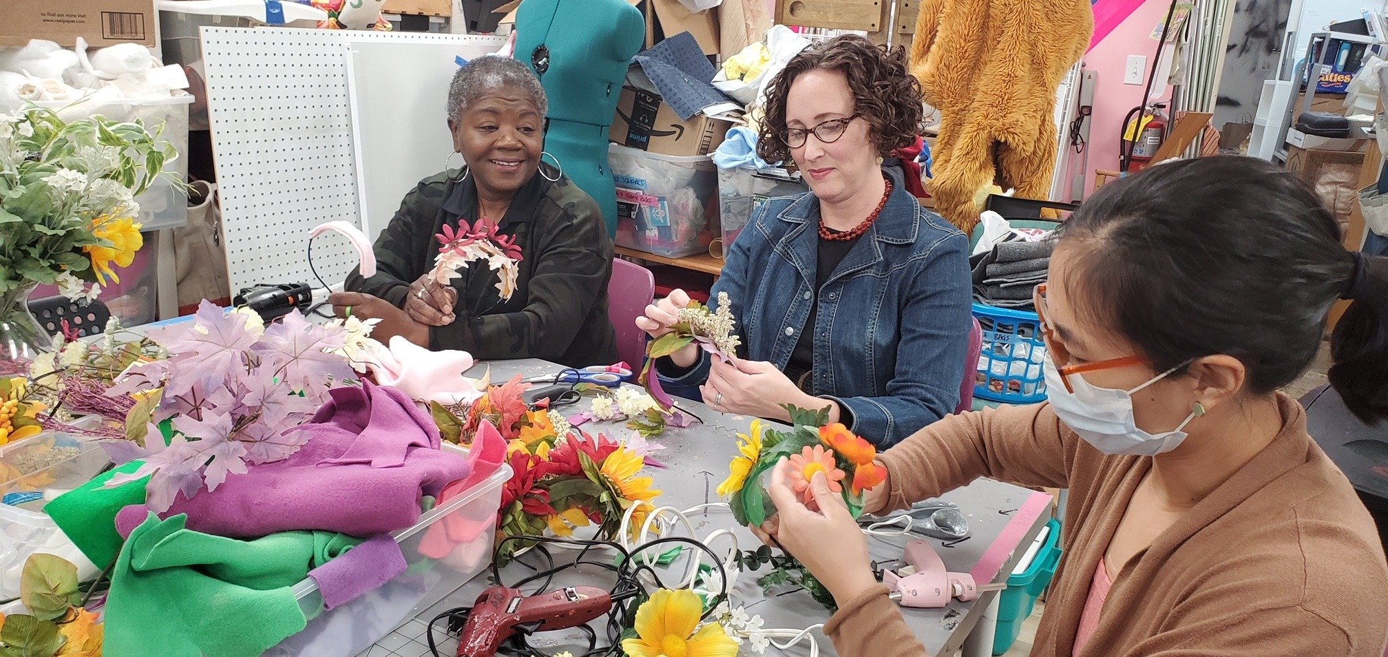 Women create flower crowns at Scraplanta workshop.