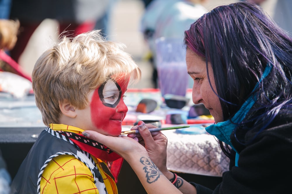 Kid getting face painted
