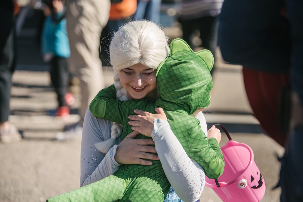 Mom and child hugging in costume