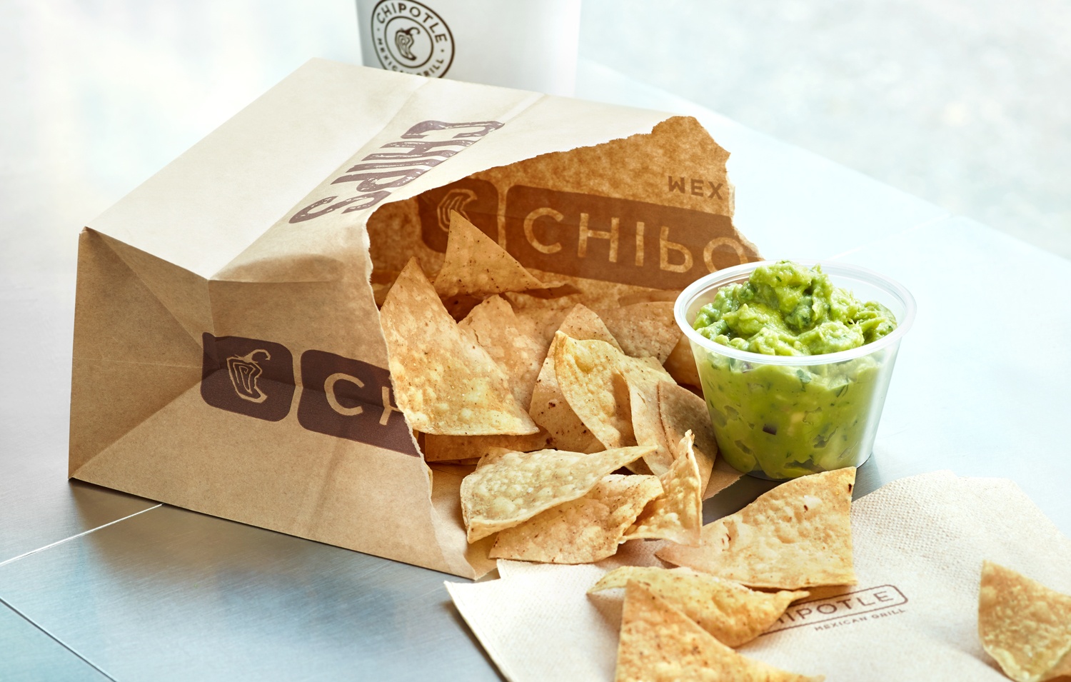 Chipotle chips and guacamole in brown bag