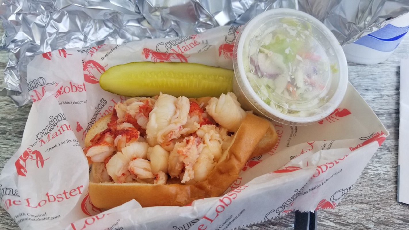 Cousins lobster roll with pickles and coleslaw