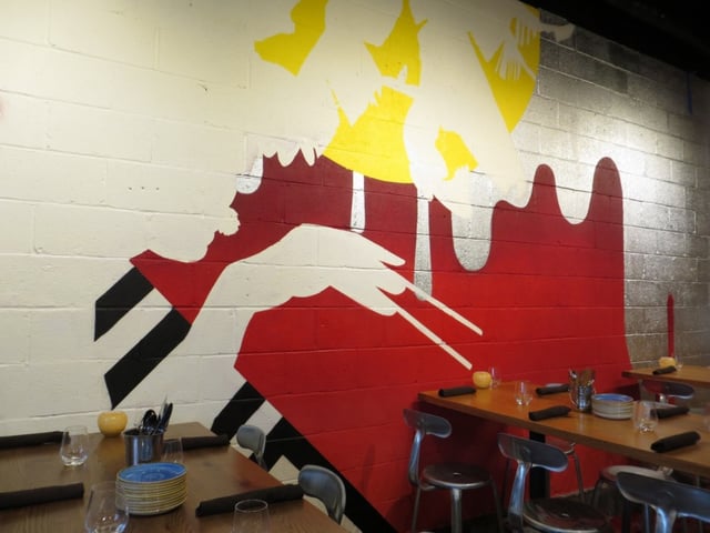 wall art inside the restaurant of a silhouetted man holding chopsticks