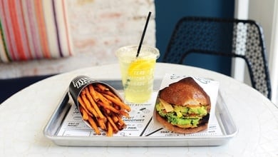 tray of burger, fries, and lemonade on a table