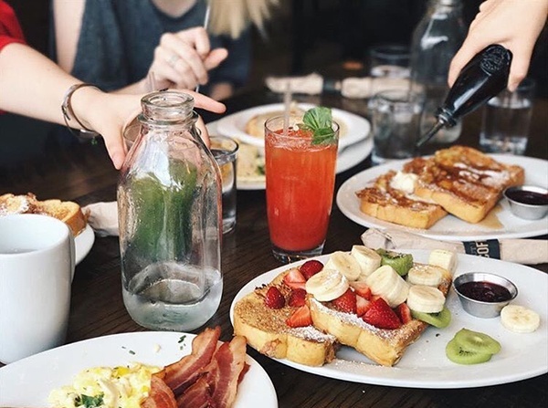 Customers enjoying breakfast meals. 