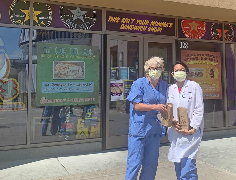 Health care workers outside Ike's Sandwiches