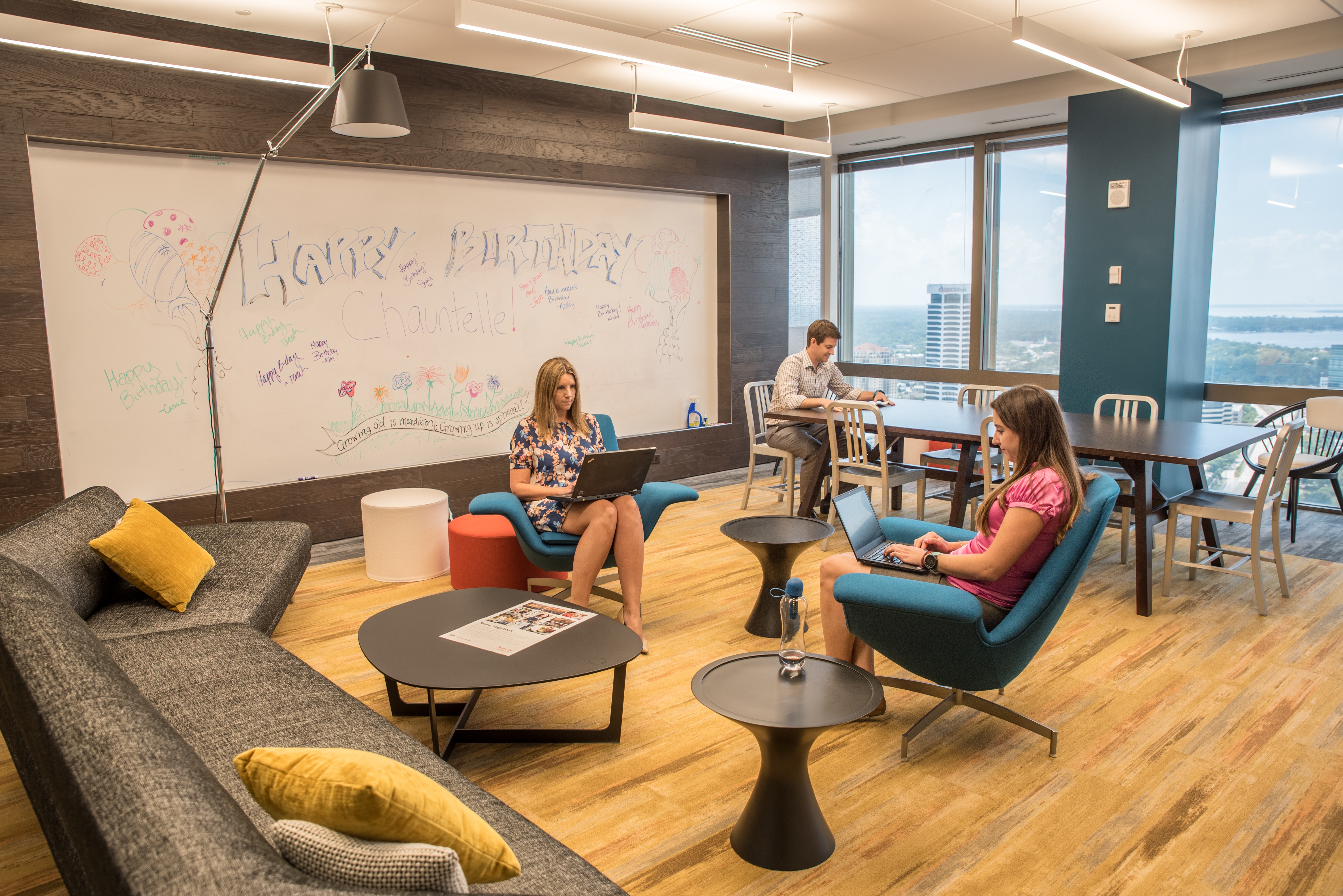 inside of an Communal work space in Jacksonville with a couch and large white board