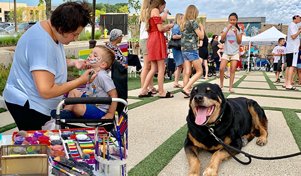 Young boy getting face painted and big dog lounging outside