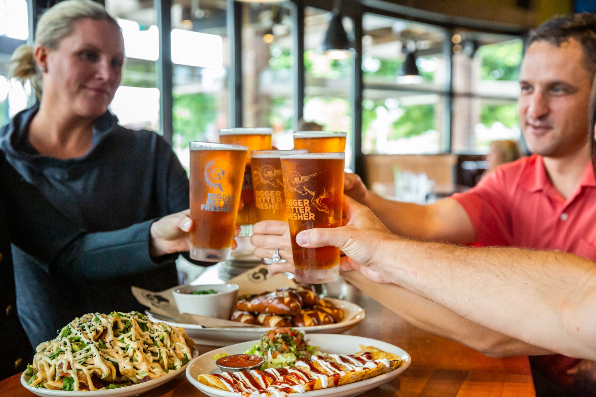 table of people doing a cheers with their beer from RAM Restaurant and Brewery