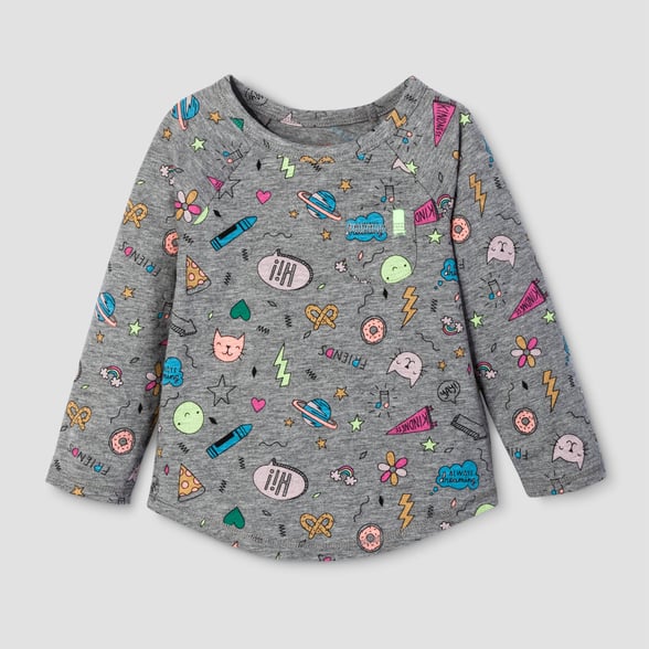 A child's grey sweater covered in colorful illustrations