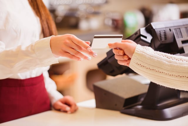 Regency March Blog1.jpg A shopper handing their credit card to an employee