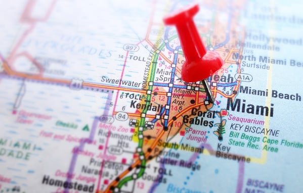 Close-up of a red pushpin on a map of South Florida. 