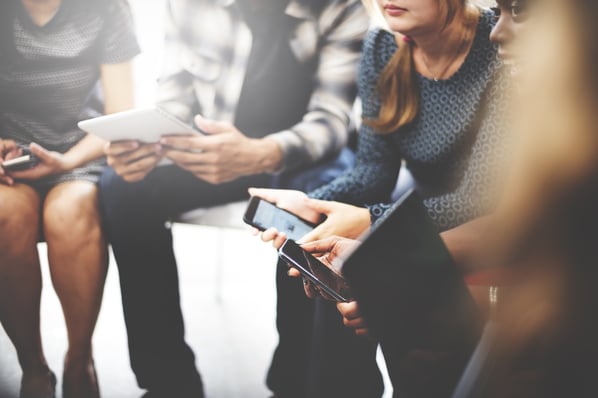 Regency May Blog7.jpg People sitting in a circle while holding various phones and tablets