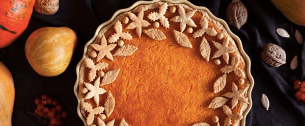 Close-up of a pumpkin pie and autumnal vegetables. 