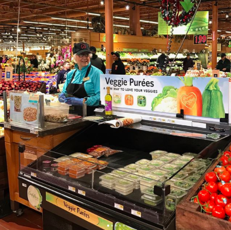 Wegmans employee inside store.  