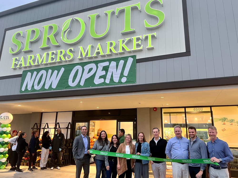 Regency team at ribbon cutting for Sprouts Farmers Market at Circle Marina Center.